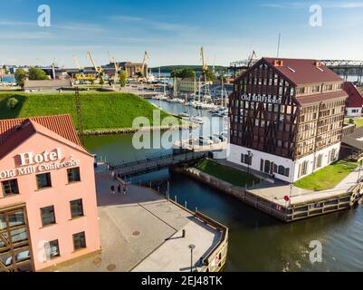 KLAIPEDA, LITHUANIA - AUGUST 9, 2020: Aerial view of beautiful yachts by the pier in the yacht club in Klaipeda, Lithuania. Klaipeda old castle site. Stock Photo