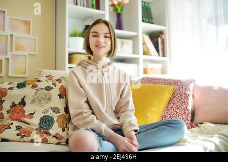 Beautiful teenage girl recording a video blog. Young vlogger shooting vlog at home. Teen influencer creating content for her social media account. Soc Stock Photo