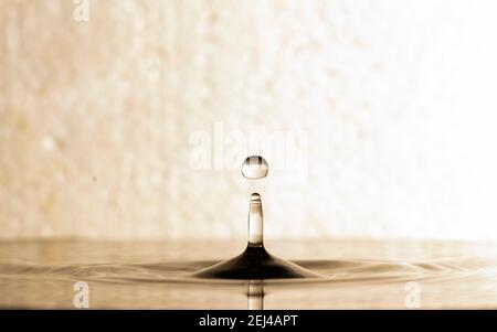 form of water droplets after falling on rippled water surface Stock Photo