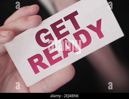 Get ready, message on business card shown by a businessman. Business risk management concept. Exams concept. Stock Photo