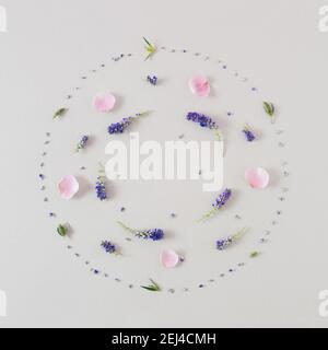 Creative  composition made with pink and blue  flowers on pastel gray  background. Flat lay. Spring, summer,  Easter minimal concept. Stock Photo