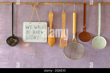 reopen sign, restaurant or cafe ready to service after corona lockdown, kitchen utensils and message,copy space Stock Photo