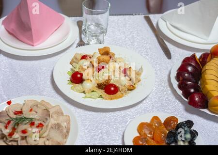 Table setting, food and decorations for important and family events, delicious snacks and hot dishes.2020 Stock Photo