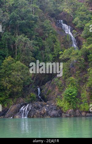 Waterfall dropping right in the ocean on Dome island, Mergui or Myeik Archipelago, Myanmar Stock Photo