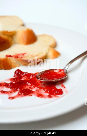 Jam and slice of braided butter, raspberry jam Stock Photo