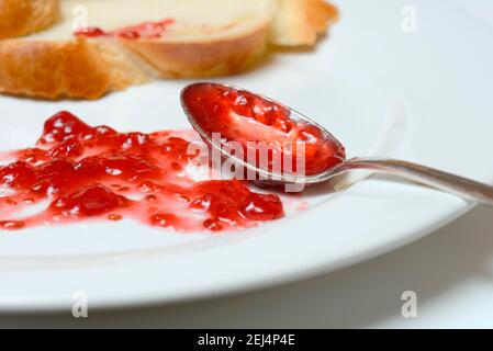 Jam and slice of braided butter, raspberry jam Stock Photo