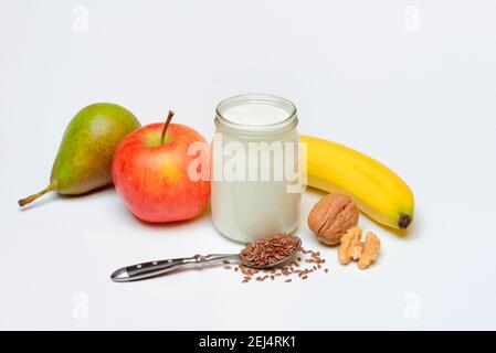 Yoghurt in glass with fruits and linseed Stock Photo