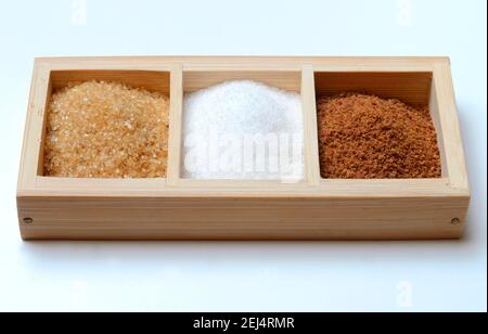 Different kinds of sugar, cane sugar, household sugar, palm sugar in box, white sugar, brown sugar, granulated sugar Stock Photo