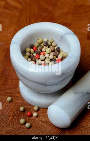 Peppercorns in grated shell, pepper, white, green, black ( Piper nigrum) and pink Pfef fer Stock Photo