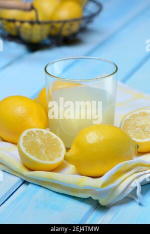 Glass of lemon juice with lemons Stock Photo