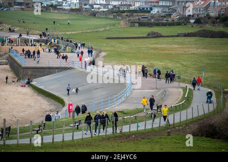 Heysham, Lancashire, United Kingdom. 21st Feb, 2021. People exercising on the Promenade at Heysham Credit: PN News/Alamy Live News Stock Photo