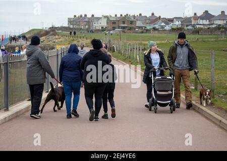 Heysham, Lancashire, United Kingdom. 21st Feb, 2021. People on the promenade the day before Boris Johnson announces the Conservative Governments Road Map to exit the UK out of Lockdown Credit: PN News/Alamy Live News Stock Photo