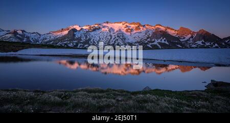 Maladeta Massif and the Aneto summit, the hightest peak in the Pyrenees, in a summer sunrise, seen from the path to the port of Benasque. (Spain) Stock Photo