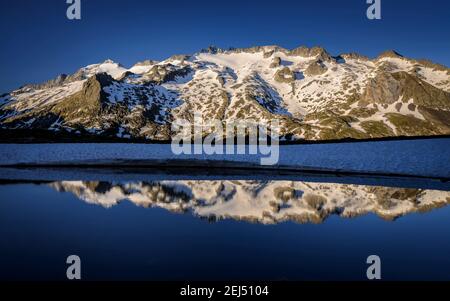 Maladeta Massif and the Aneto summit, the hightest peak in the Pyrenees, in a summer sunrise, seen from the path to the port of Benasque. (Spain) Stock Photo