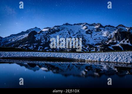 Maladeta range and the Aneto peak at night with the Moon. Viewed from the other side of the valley, near to Port de Benasque (mountain pass, Benasque) Stock Photo