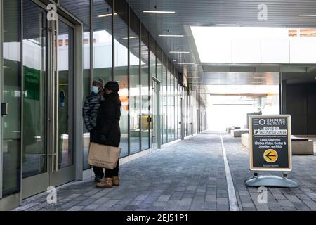 Staten Island, New York, USA. 21st Feb, 2021. People look to see if The Empire Outlets Vaccination Center is open in Staten Island, New York. Mandatory credit: Kostas Lymperopoulos/CSM/Alamy Live News Stock Photo