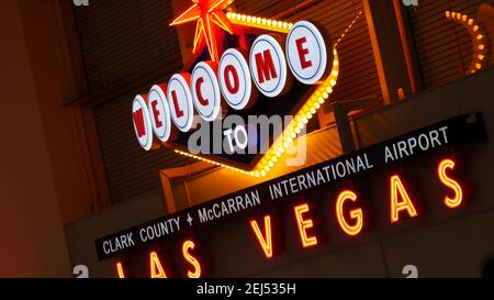 LAS VEGAS, NEVADA USA - 9 MAR 2020: Welcome to fabulous Sin City illuminated retro neon sign inside McCarran airport. Iconic greeting vintage styled s Stock Photo