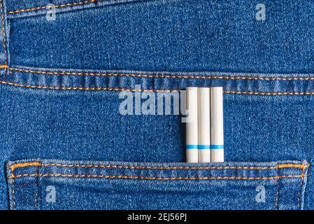 slim cigarettes in the jeans pocket on back side Stock Photo
