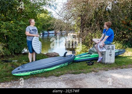 Mother and daughter drying off after having been kayaking in inflatable kayaks on the River Lea by the Walthamstow Marshes, London, UK Stock Photo