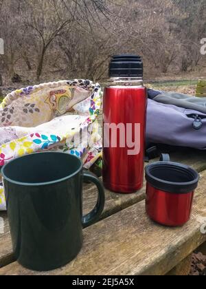 Refreshing break during a trek in a natural park.Hot herbal tea with berries. Stock Photo