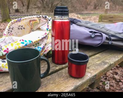 Refreshing break during a trek in a natural park.Hot herbal tea with berries. Stock Photo