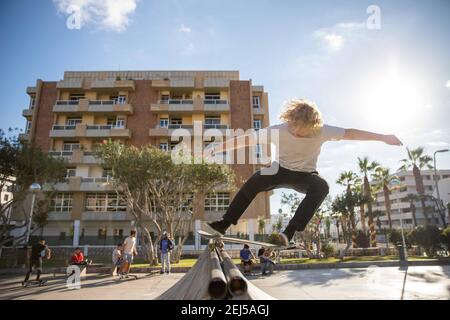 Boy has fun with his skate in the ramp at the skatepark Stock Photo