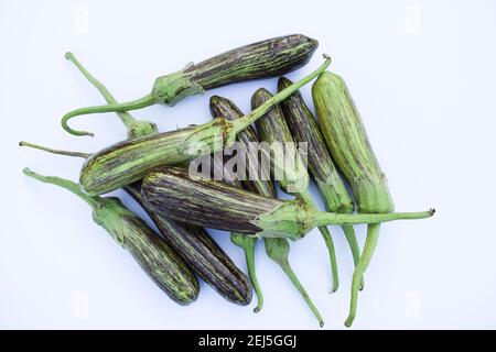 Brinjals also called Eggplants and aubergines. Green and purple dual stripe types of eggplant from India. Fresh Indian vegetables harvested at home or Stock Photo