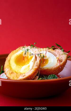 Typical British dish Scotch egg. red background. Stock Photo