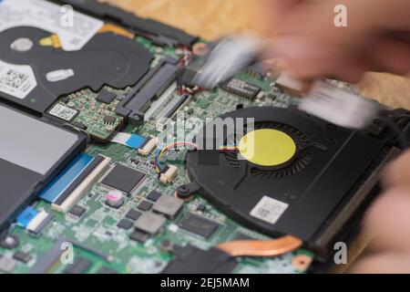 Technician repairing a laptop motherboard Stock Photo