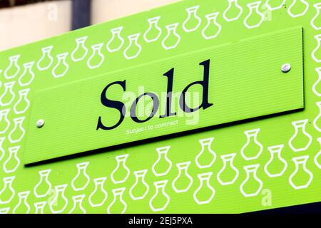 Green Sold sign outside a sold propery Stock Photo