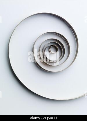 Clock spiral spring abstract. On white paper Background. Stock Photo