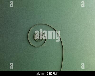 Clock spiral spring abstract. On green paper Background. Stock Photo