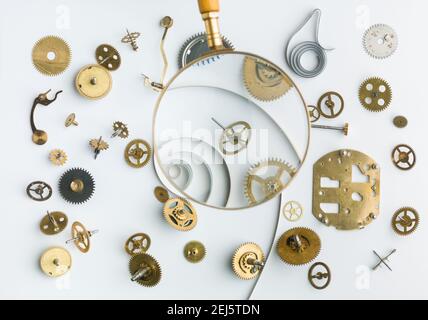 Clockwork spare parts. Metal gear, cogwheels and other details. Viewed thru a magnifying glass Stock Photo