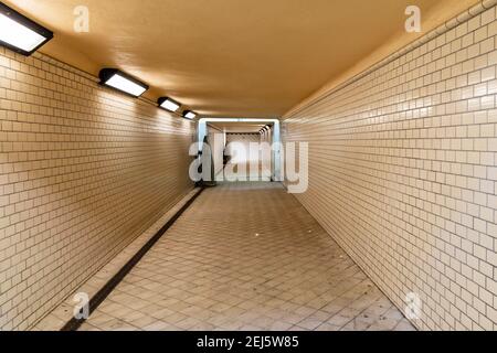 Wroclaw, Poland - February 20 2020 Long tunnel with white tiles under train platforms Stock Photo
