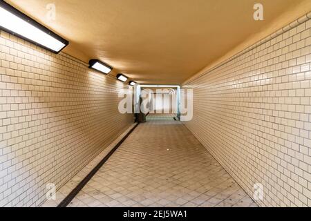 Wroclaw, Poland - February 20 2020 Long tunnel with white tiles under train platforms Stock Photo