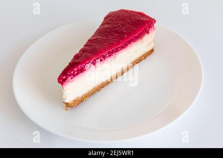Close up of Cheesecake slice on white plate. Raspberry cheesecake. Copy space. selective focus Stock Photo