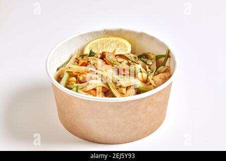 Pad thai noodle cube with chicken zucchini and cashew nuts isolated on white background. Stock Photo