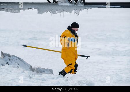 Cleveland, Ohio, USA. 21st Feb, 2021. A Cleveland Firefight makes his way to the ice as people are rescued off the ice of Lake Erie by members of the USCG Ice Rescue Team from Station Cleveland, as well as other local rescue agencies, late Sunday afternoon, February 21, 2021 at Edgewater Park in Cleveland, Ohio. At 12:43 EST, the National Weather Service in Cleveland issue a warning to not go onto the ice due to development of significant cracks from southerly winds. According to a Tweet from the USCG Great Lake, the '''¦ USCG ice rescue team rescued 6 individuals via the ice skiff and th Stock Photo