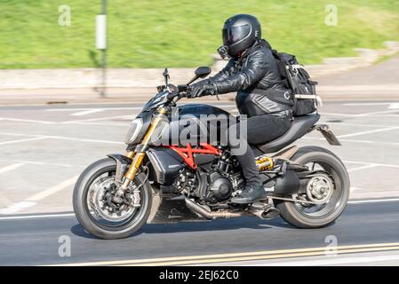 Ducati Diavel 1260S motorcycle being ridden in Southend on Sea, Essex, UK, on a bright sunny winter day, during COVID 19 lockdown. Black cruiser bike Stock Photo