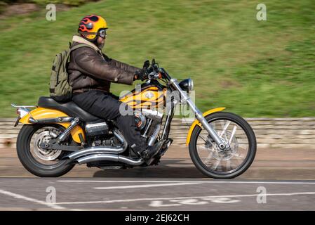 Harley Davidson motorcycle being ridden in Southend on Sea, Essex, UK, on a bright sunny winter day, during COVID 19 lockdown. Flame graphics paint Stock Photo