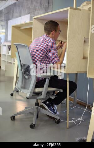 businessman working at a table in a shared office coworking space Stock Photo