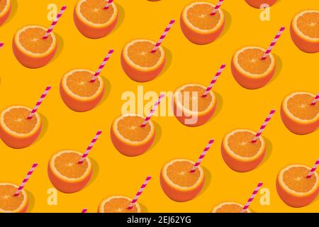 Fruit pattern of fresh orange half with straws on orange background. Minimal Pop art design, creative summer concept. Copy space Stock Photo