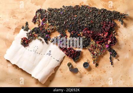 Continent Eurasia made of different sorts of tea and travel items on color background Stock Photo