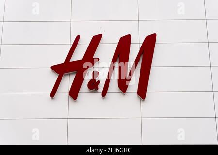 The logo of H&M, the Swedish fashion retailer, displayed large in a ...