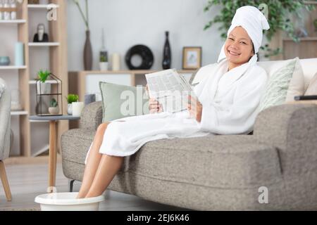 woman soaking feet in a bowl at home Stock Photo