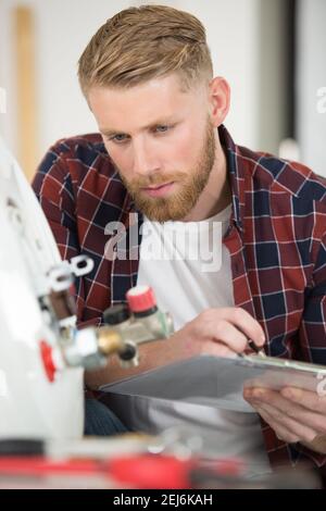 male plumber working on central heating boiler Stock Photo