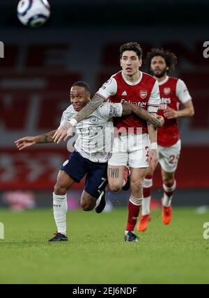 London, Britain. 21st Feb, 2021. Manchester City's Raheem Sterling (L) vies with Arsenal's Hector Bellerin during the English Premier League football match between Arsenal and Manchester City at the Emirates Stadium in London, Britain, on Feb. 21, 2021. Credit: Han Yan/Xinhua/Alamy Live News Stock Photo