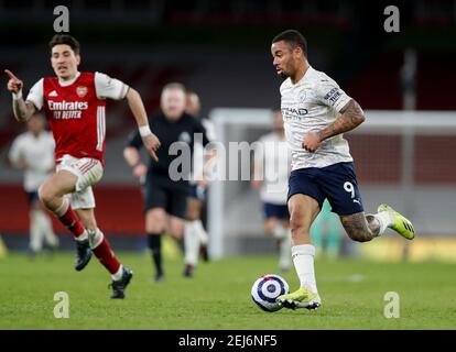 London, Britain. 21st Feb, 2021. Manchester City's Gabriel Jesus (R) breaks through during the English Premier League football match between Arsenal and Manchester City at the Emirates Stadium in London, Britain, on Feb. 21, 2021. Credit: Han Yan/Xinhua/Alamy Live News Stock Photo