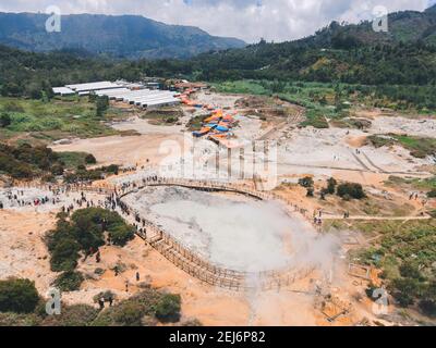 Aerial view of Sikidang crater with the background of sulfur vapor coming out of the sulfur marsh. Stock Photo