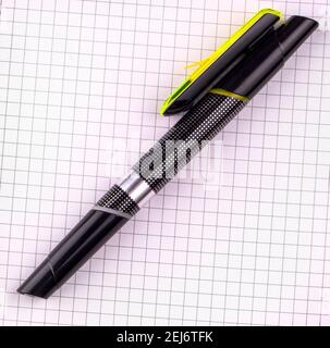 The black pen for writing on white checkered notebook paper Stock Photo